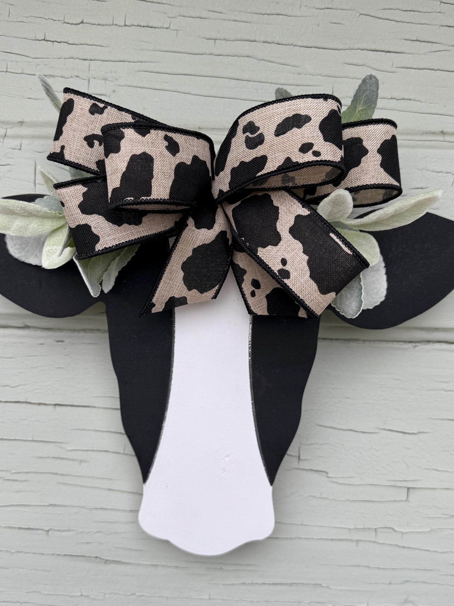 Wooden Cow Head with greenery and bow