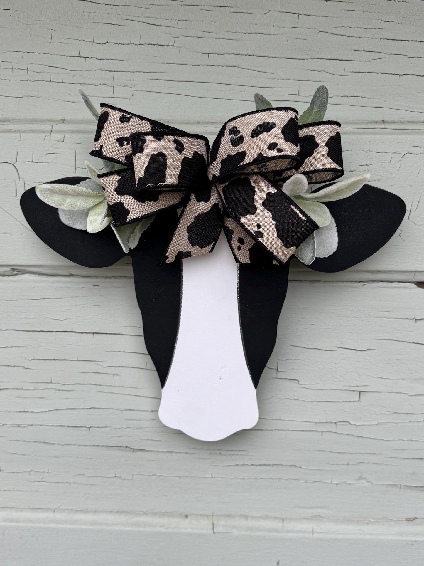 Wooden Cow Head with greenery and bow