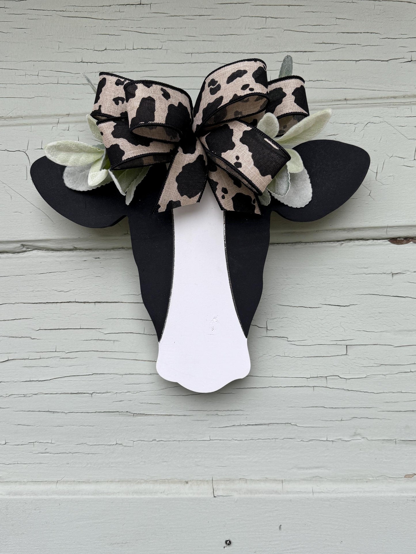 Wooden Cow Head with greenery and bow